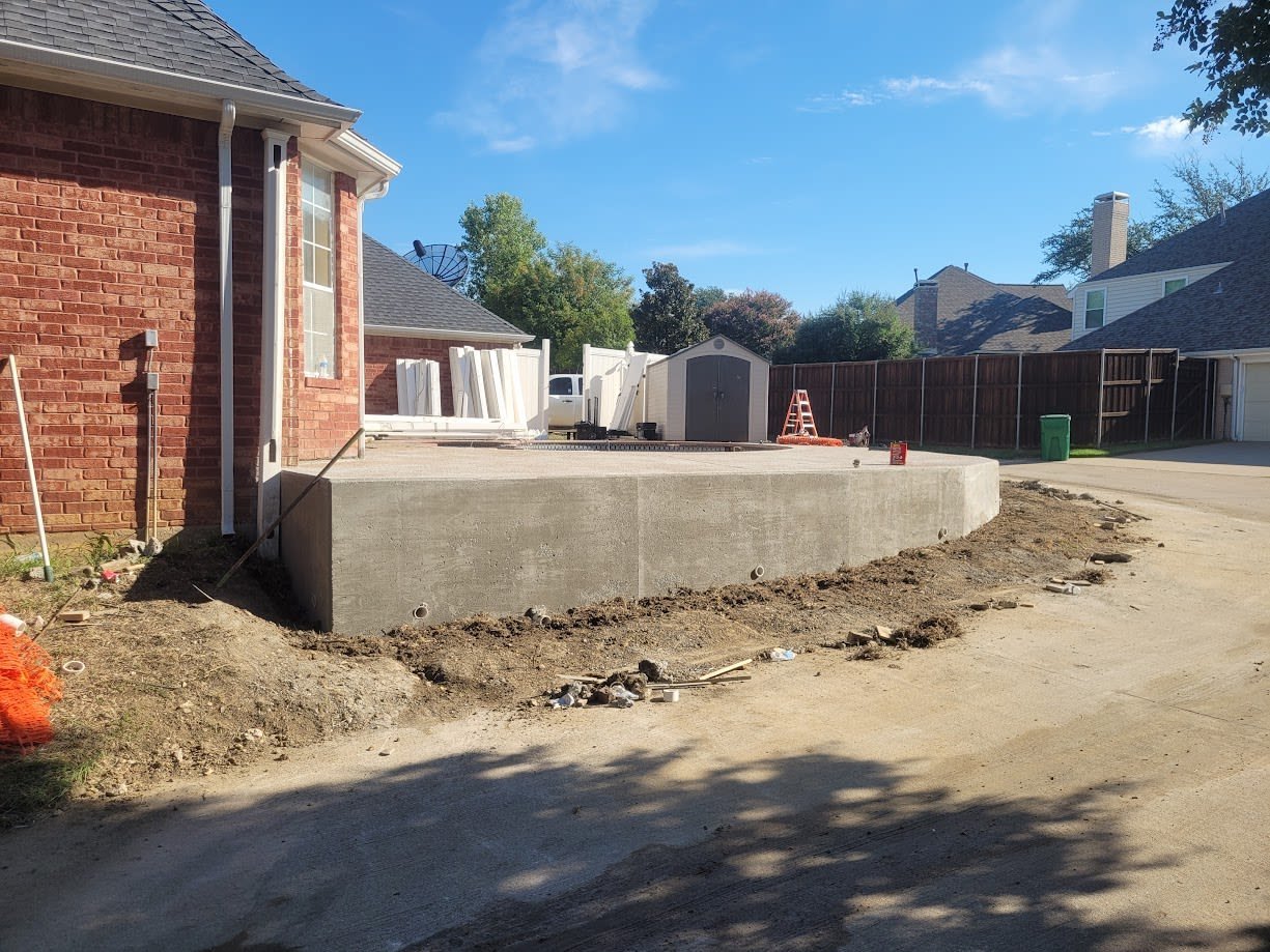 Concrete pool with a decorative deck and water feature
