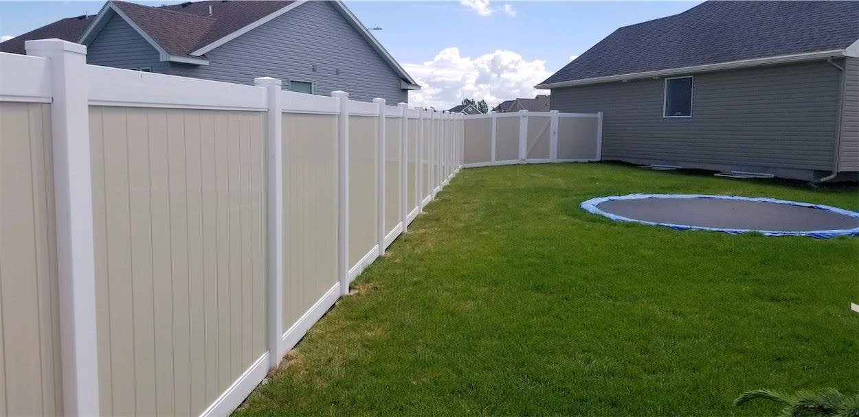Vinyl picket fence along a front lawn