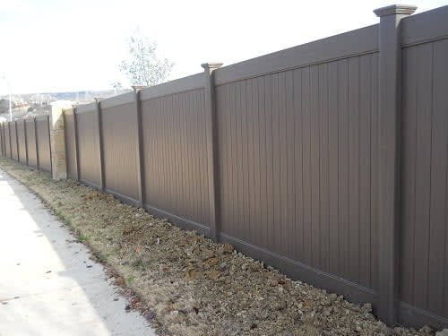 Vinyl privacy fence enclosing a backyard