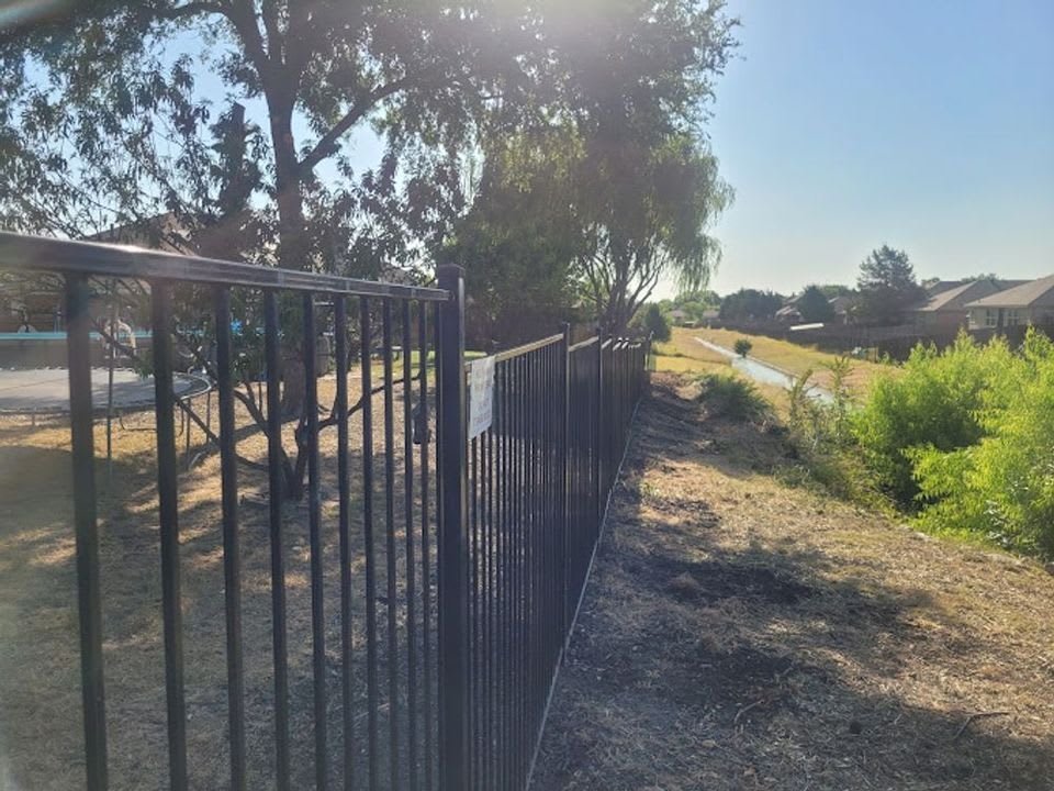 Wrought iron gate set into a fence line