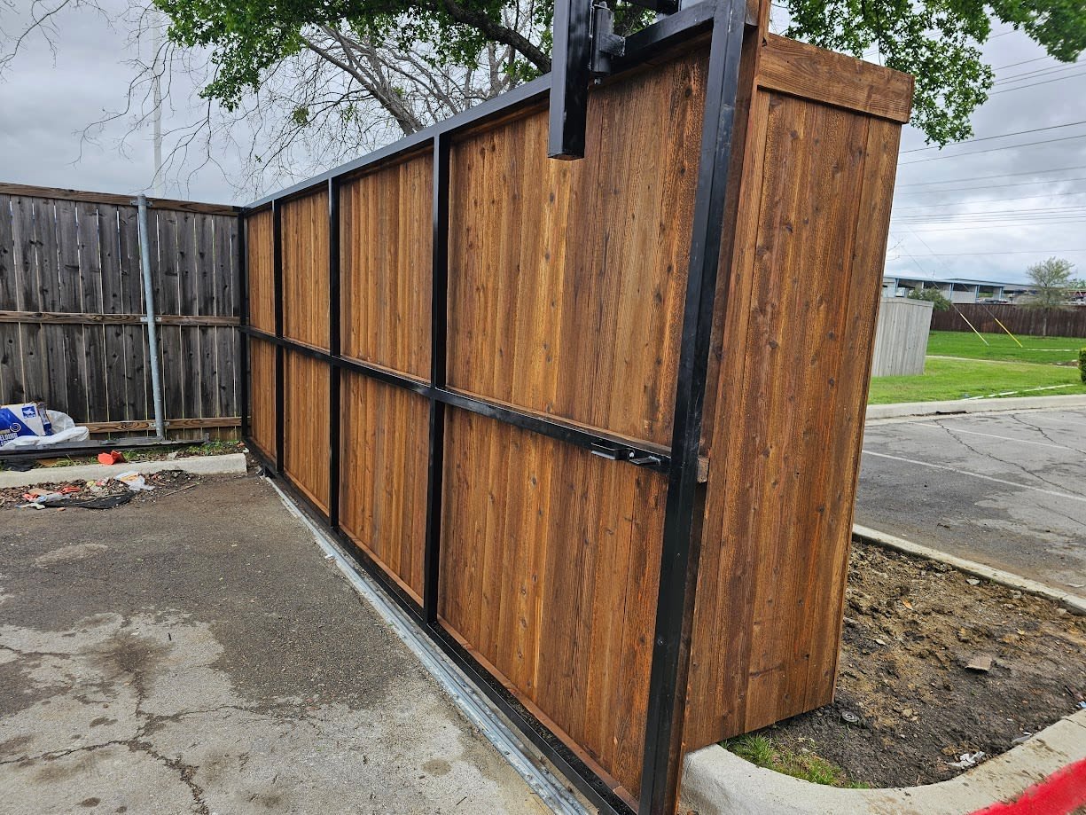 Sliding gate set into a fenced property boundary