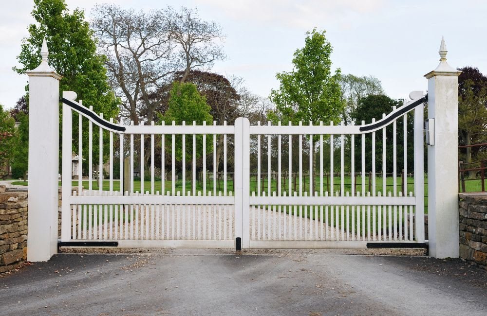 Ornamental metal swing gate flanked by brick columns