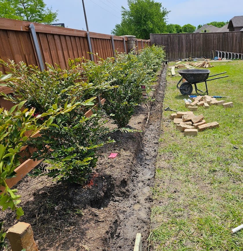 Colorful flower bed bordering a Texas home's landscaping