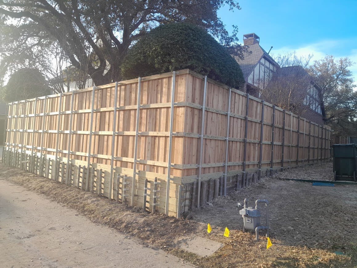 Treated pine retaining wall holding back a Dallas landscape